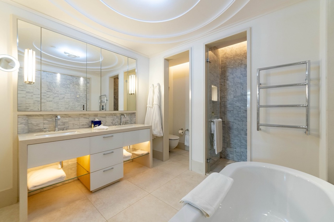Modern bathroom in an apartment in Porto Montenegro, Tivat, Montenegro: marble finishes, bathtub and shower.