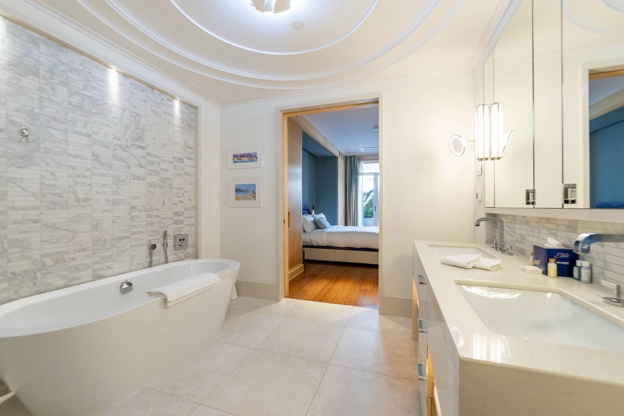 Modern bathroom in an apartment in Porto Montenegro, Tivat, Montenegro: marble finishes and a view of the bedroom.
