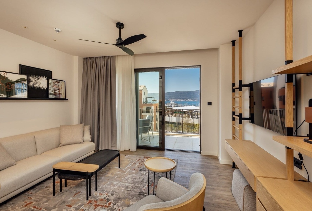 Modern living room in Porto Montenegro apartments, Tivat, Montenegro, with marina view and terrace.