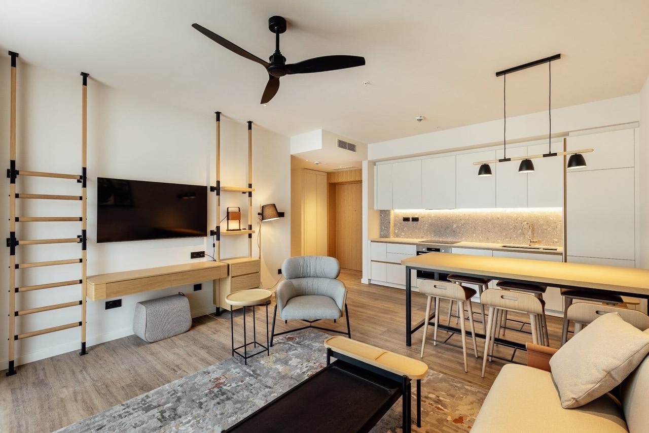 Modern living room with kitchen in Porto Montenegro apartments, Tivat, Montenegro: stylish furniture and bright interior.