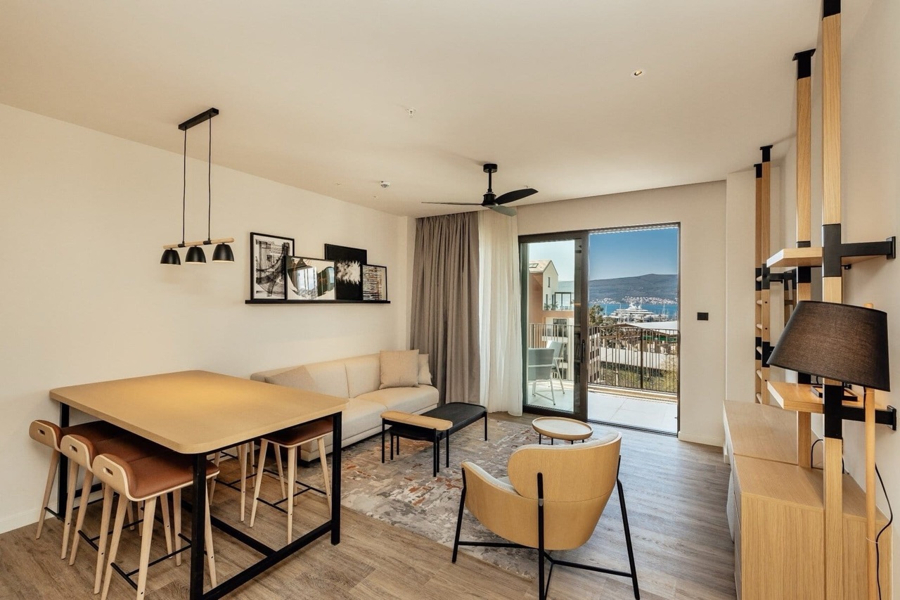Living room in an apartment in Porto Montenegro, Tivat, Montenegro: modern furniture, marina view, and balcony.