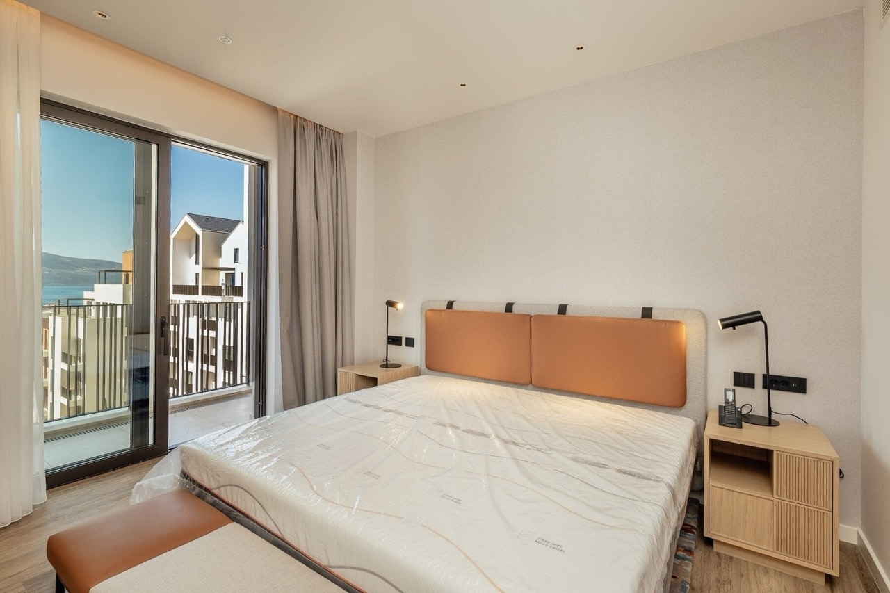 Modern bedroom with a double bed and sea view in Porto Montenegro, Tivat, Montenegro.