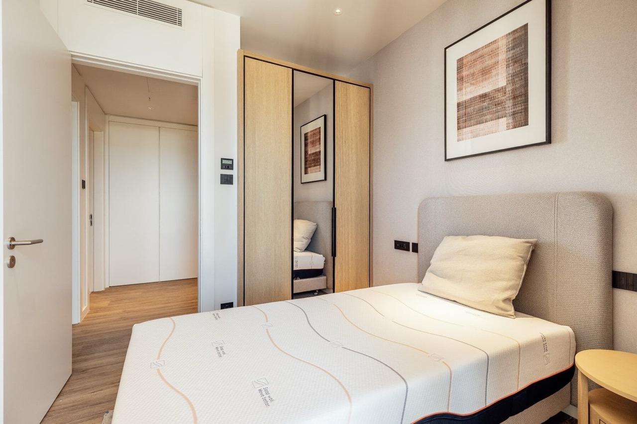 Modern bedroom with a single bed and built-in wardrobe in Porto Montenegro apartments, Tivat, Montenegro.