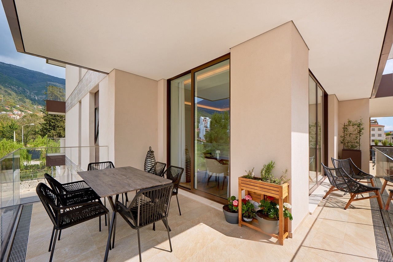 Spacious terrace with furniture in an apartment in Porto Montenegro, Tivat, Montenegro: mountain view and modern design.