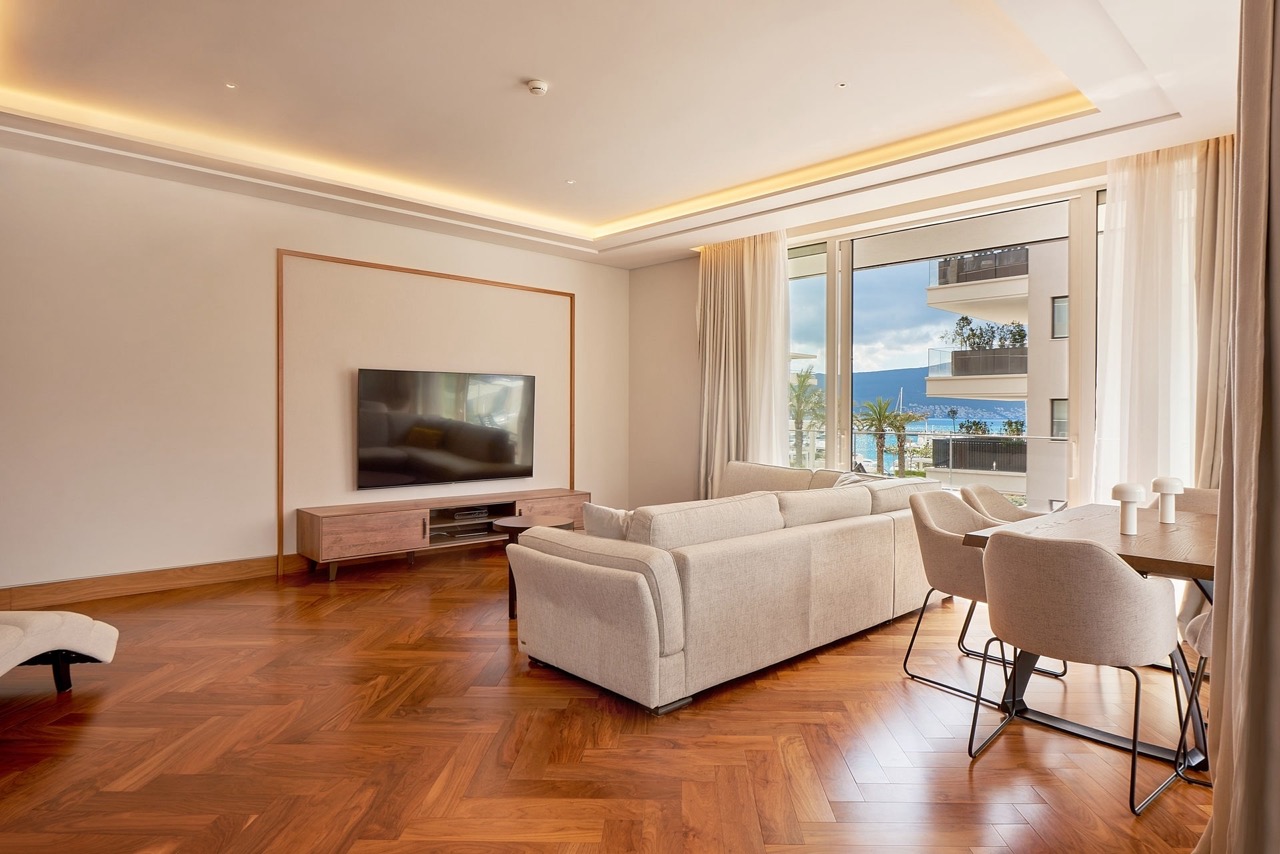Modern living room with parquet flooring and sea view in an apartment in Porto Montenegro, Tivat, Montenegro.