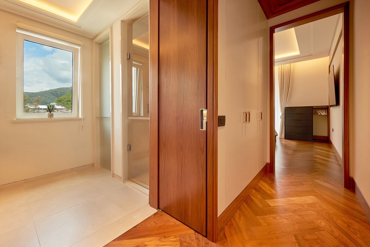 Apartment interior in Porto Montenegro, Tivat: wooden flooring, built-in wardrobes, and a view of the mountains of Montenegro.