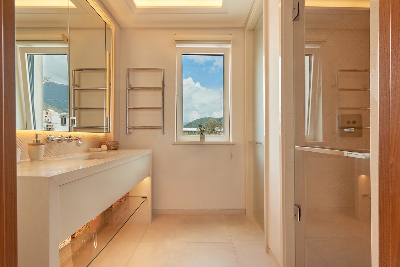 Modern bathroom with a shower cabin in an apartment in Porto Montenegro, Tivat, Montenegro, with mountain views.