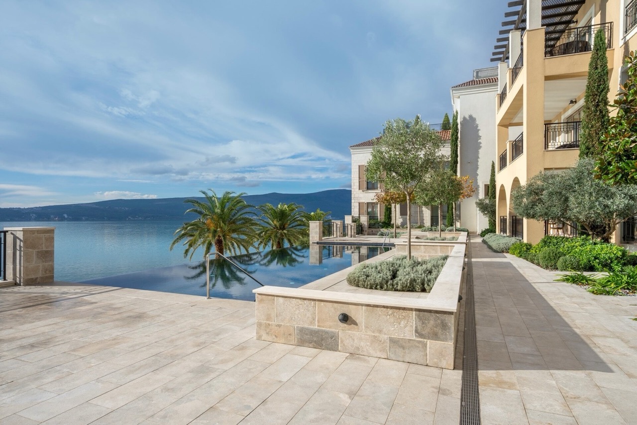 Infinity pool with sea and mountain views at a luxury residential complex in Porto Montenegro, Tivat, Montenegro.