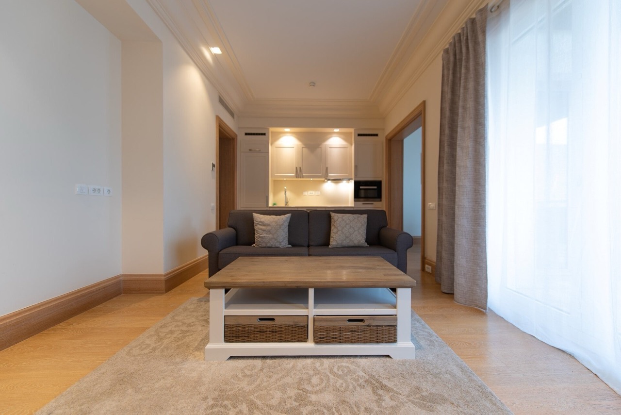 Living room with sofa and kitchen area in an apartment, Porto Montenegro, Tivat, Montenegro: modern interior and finishes.