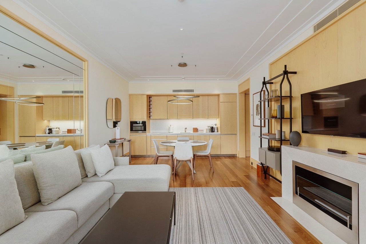 Modern living room with fireplace and kitchen in an apartment, Porto Montenegro, Tivat, Montenegro: stylish interior with furniture.
