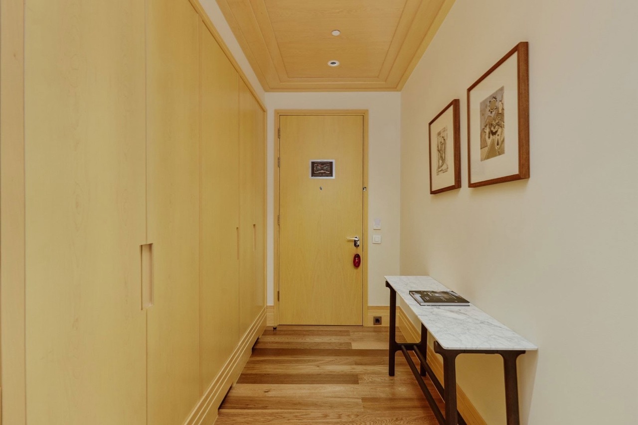Hallway in an apartment in Porto Montenegro, Tivat, Montenegro: built-in light wood wardrobe and marble console.