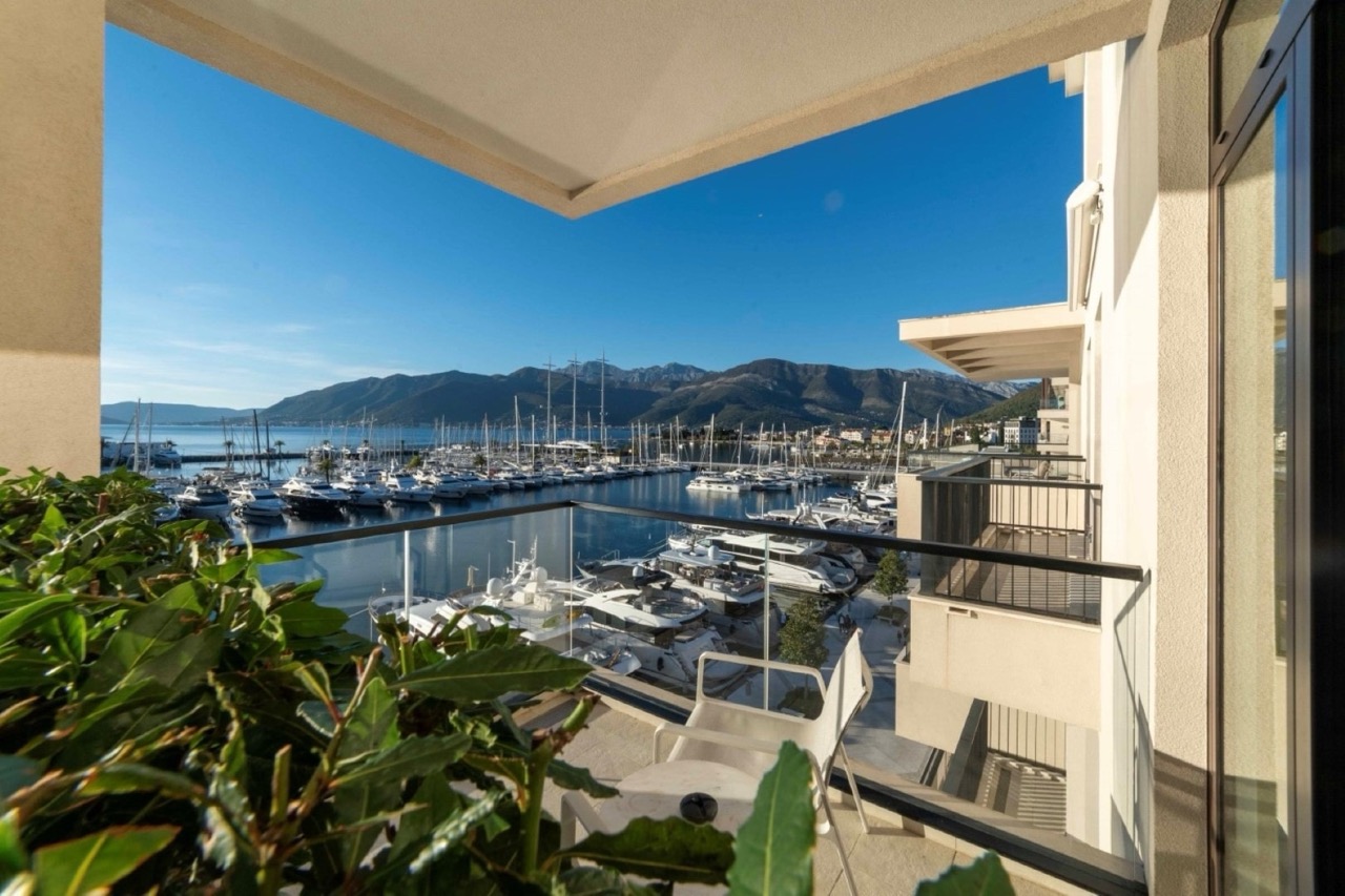 View from the apartment balcony in Porto Montenegro, Tivat, Montenegro: panoramic view of the yacht marina and mountains.