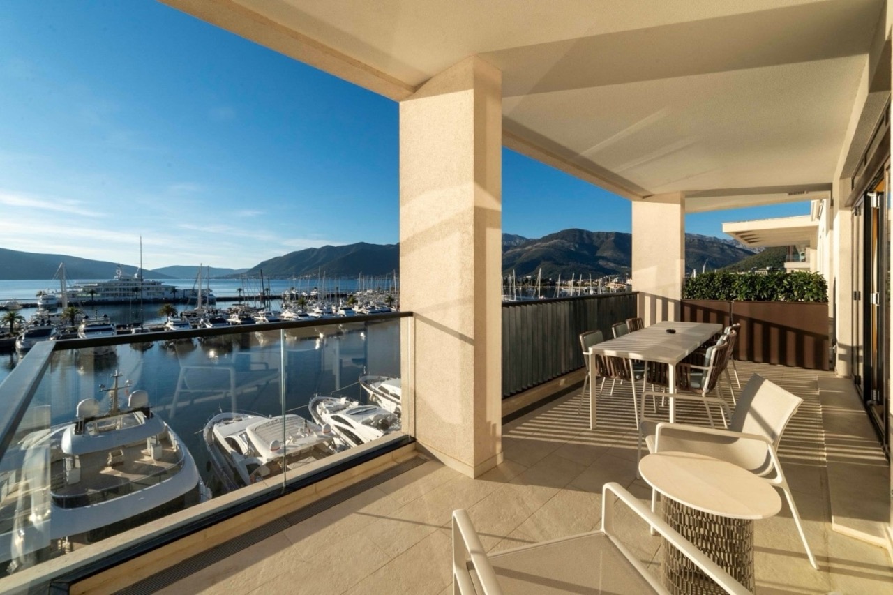 Spacious terrace with furniture and views of the Porto Montenegro yacht marina, Tivat, Montenegro.