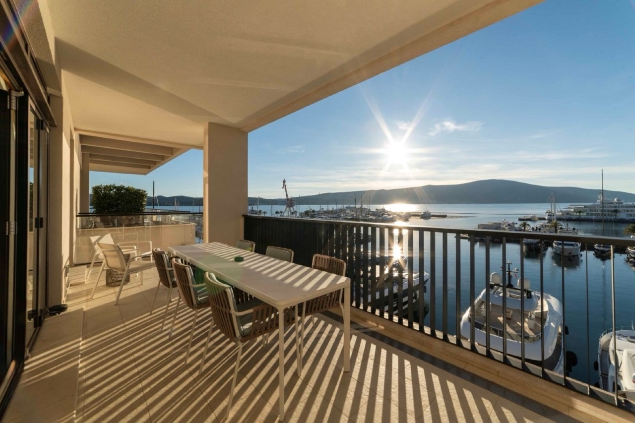 Terrace with a dining area and views of the marina and yachts in Porto Montenegro, Tivat, Montenegro.