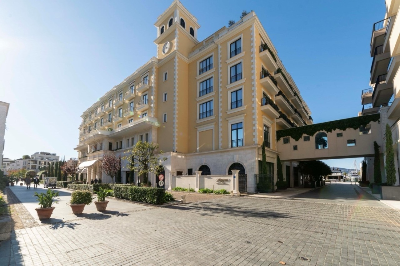 Facade of the Regent Hotel in Porto Montenegro, Tivat, Montenegro: classic architecture, balconies, and a view of the waterfront.