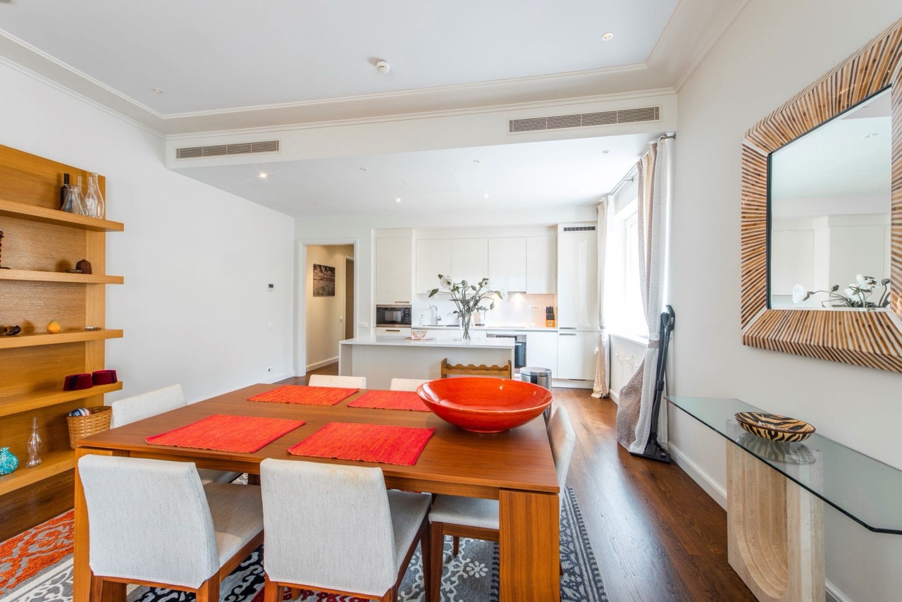 Modern living room with dining area in an apartment in Porto Montenegro, Tivat, Montenegro: bright interior, kitchen, and decor.