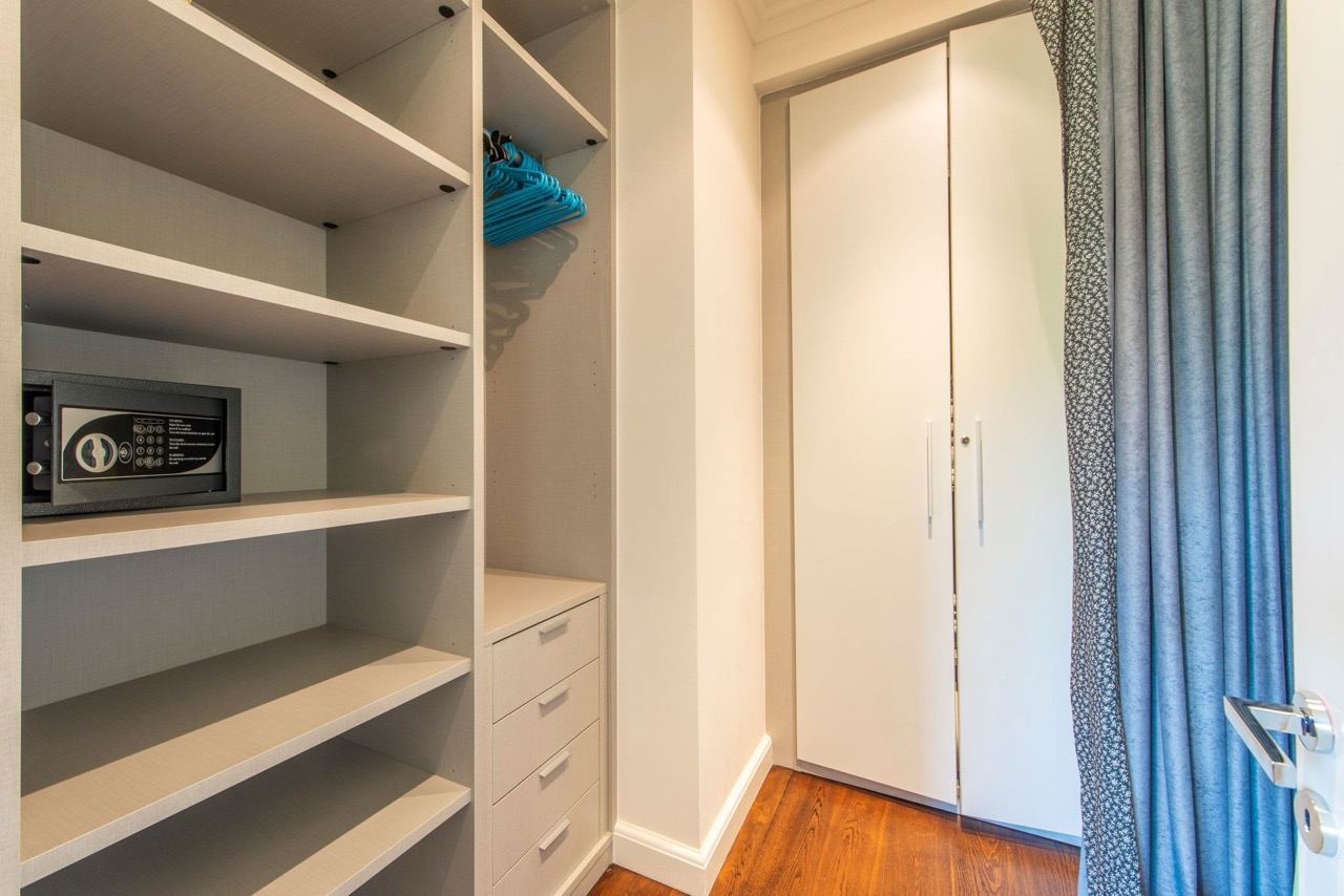 Built-in wardrobe with shelves, a safe, and drawers in the bedroom of an apartment in Porto Montenegro, Tivat, Montenegro.