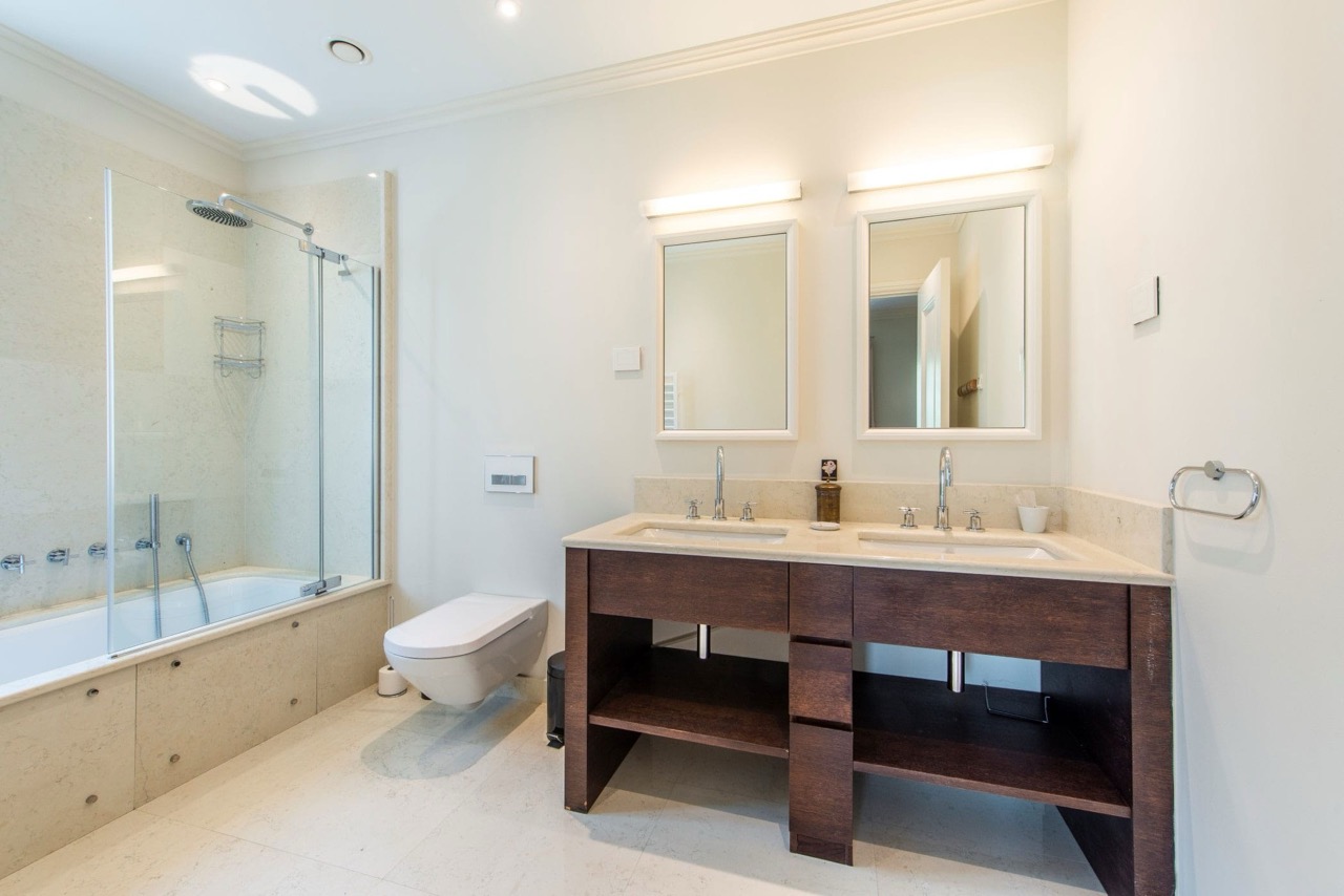Modern bathroom with two sinks and a shower cabin in an apartment in Porto Montenegro, Tivat, Montenegro.