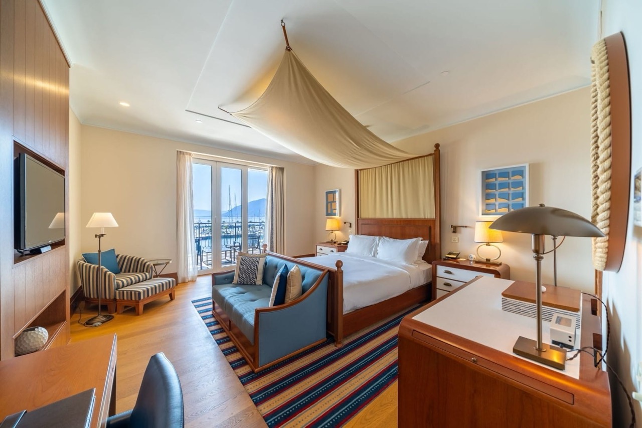 Bedroom in Porto Montenegro apartments, Tivat, Montenegro: canopy bed, marina view, and stylish interior.