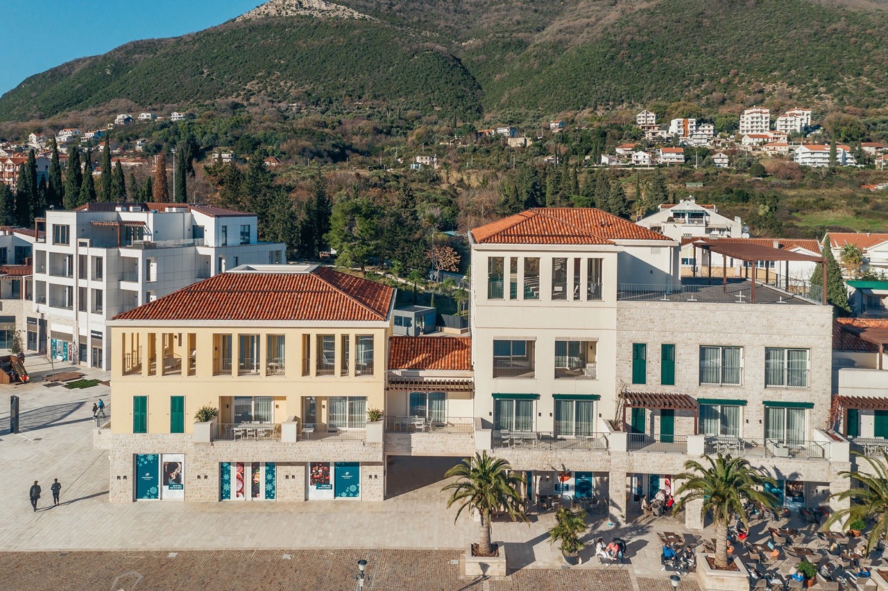Exterior view of the Portonovi residential complex in Kumbor, Montenegro: modern buildings with terraces and tiled roofs.