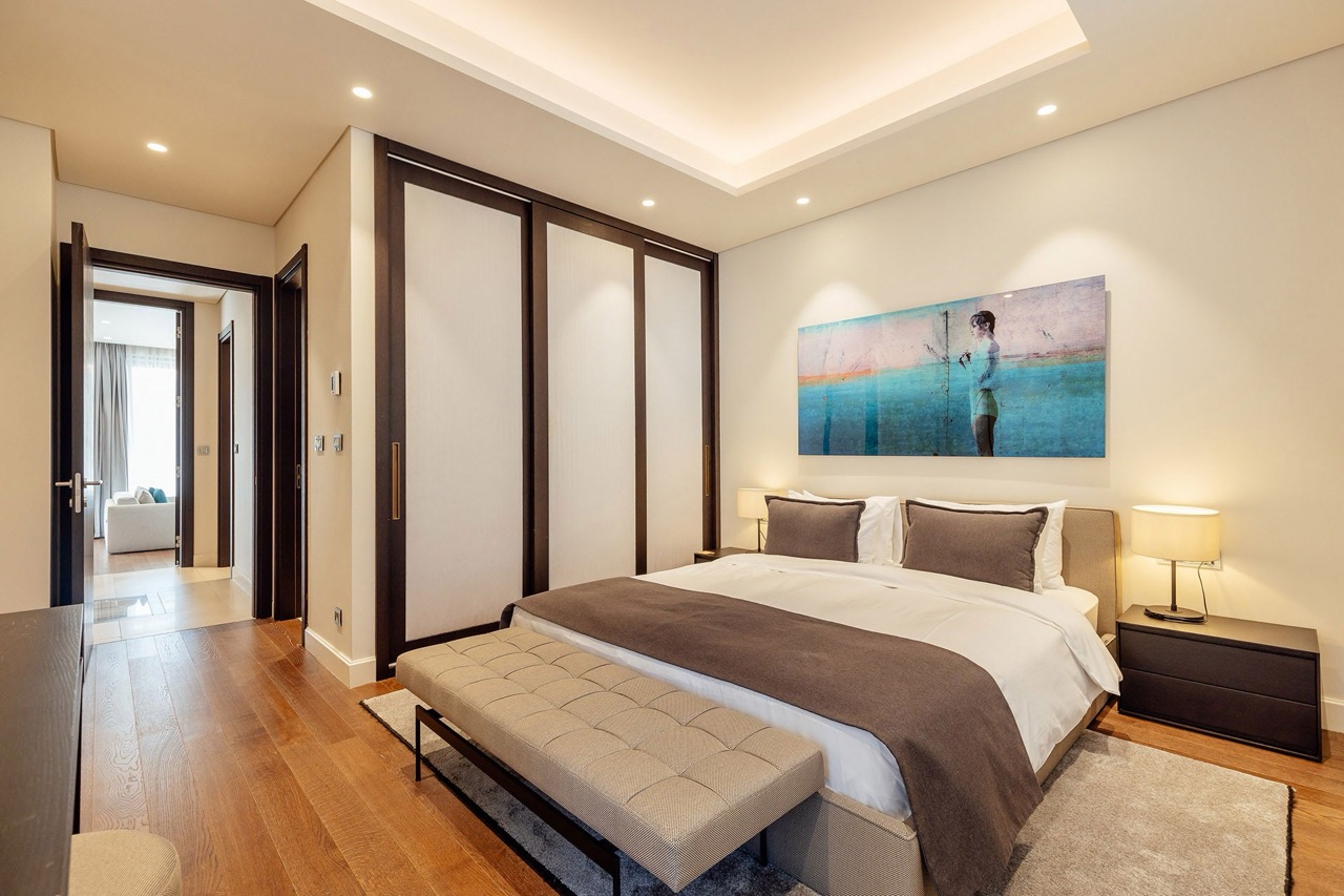 Modern bedroom with a double bed and built-in wardrobe in Portonovi apartments, Kumbor, Montenegro.