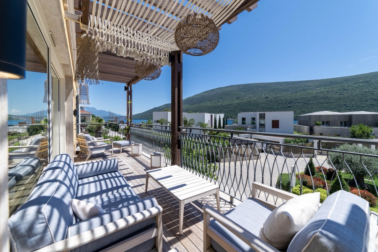 Terrace with wicker furniture and sea view in the Portonovi residential complex, Kumbor, Montenegro.