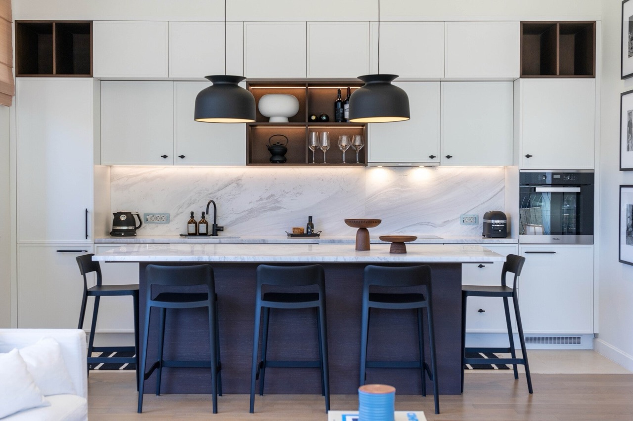 Modern kitchen with a marble island and bar stools in an apartment in Portonovi, Kumbor, Montenegro.
