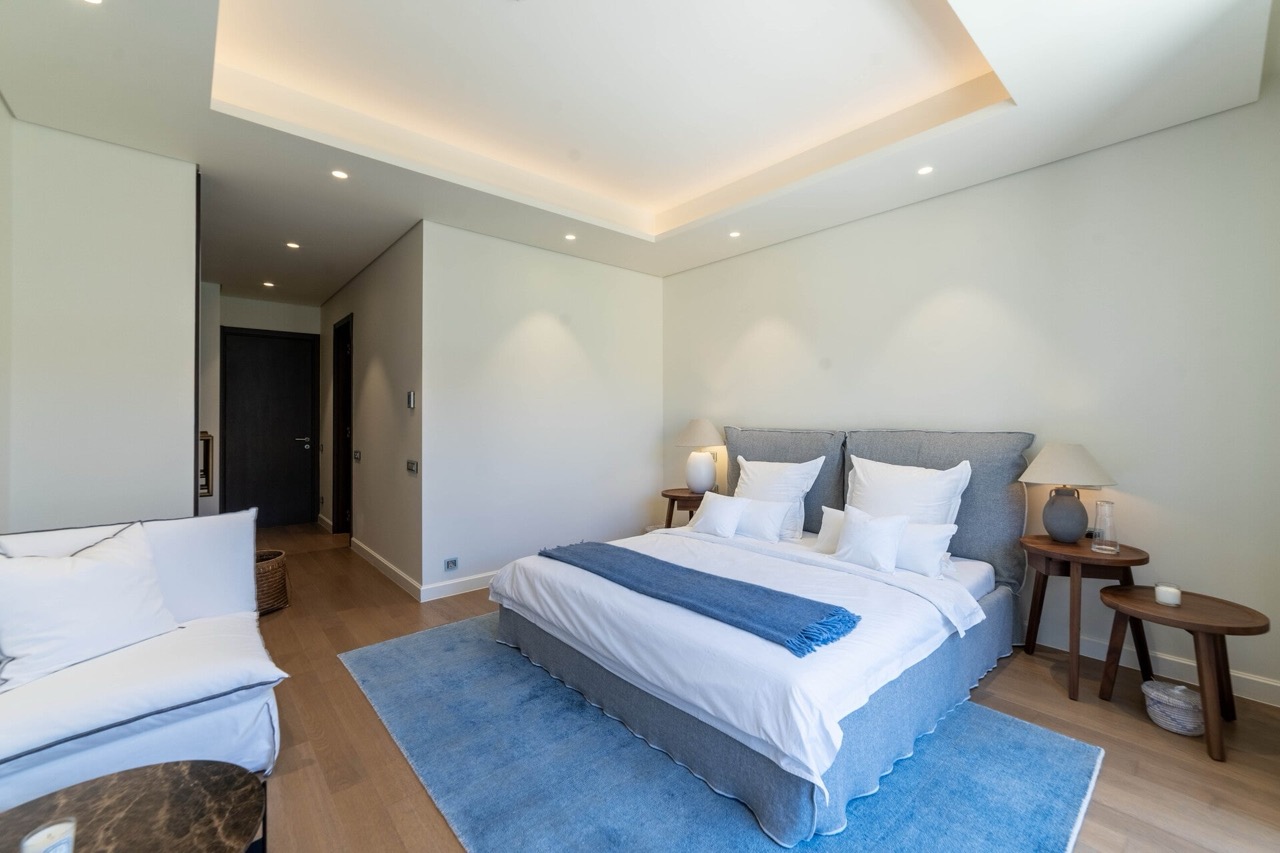 Modern bedroom in an apartment in Portonovi, Kumbor, Montenegro: double bed, parquet flooring, and stylish interior.