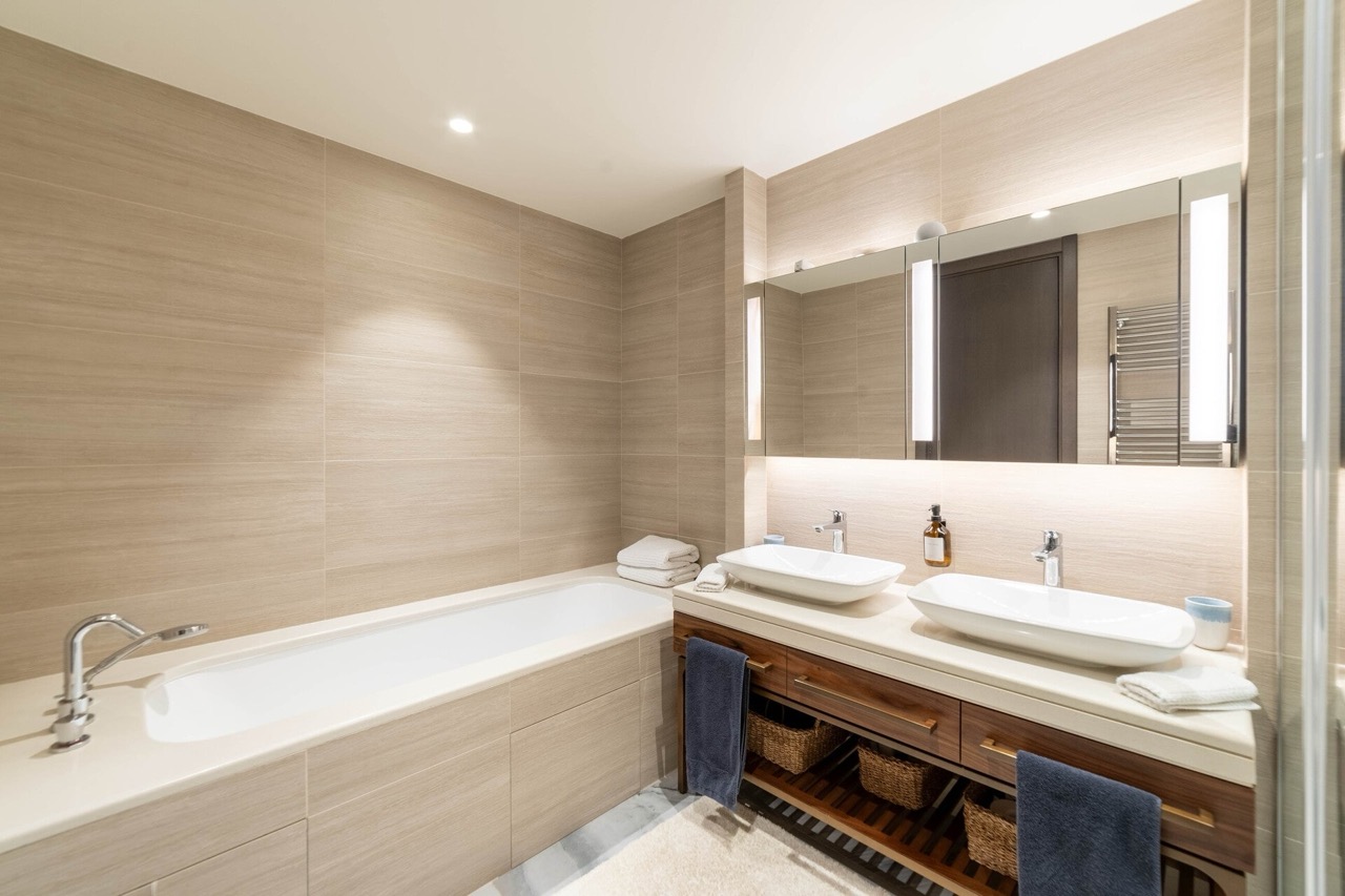 Modern bathroom with two sinks and a bathtub in an apartment in Portonovi, Kumbor, Montenegro.