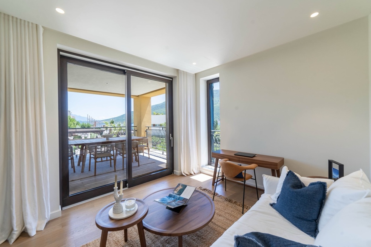 Living room with access to the terrace in Portonovi apartments, Kumbor, Montenegro: modern furniture and sea view.