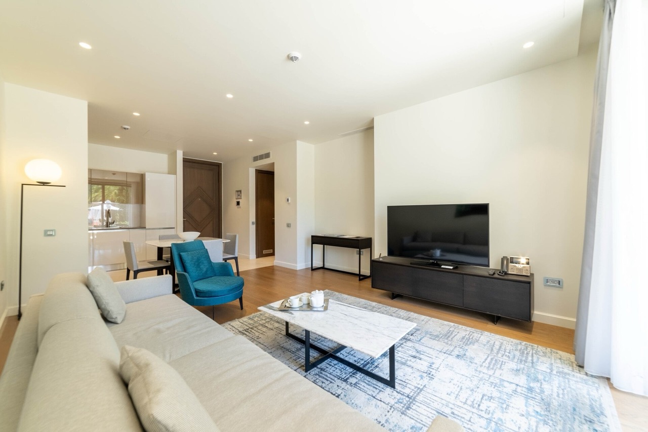 Modern living room with soft seating and kitchen in the Portonovi apartments, Kumbor, Montenegro.