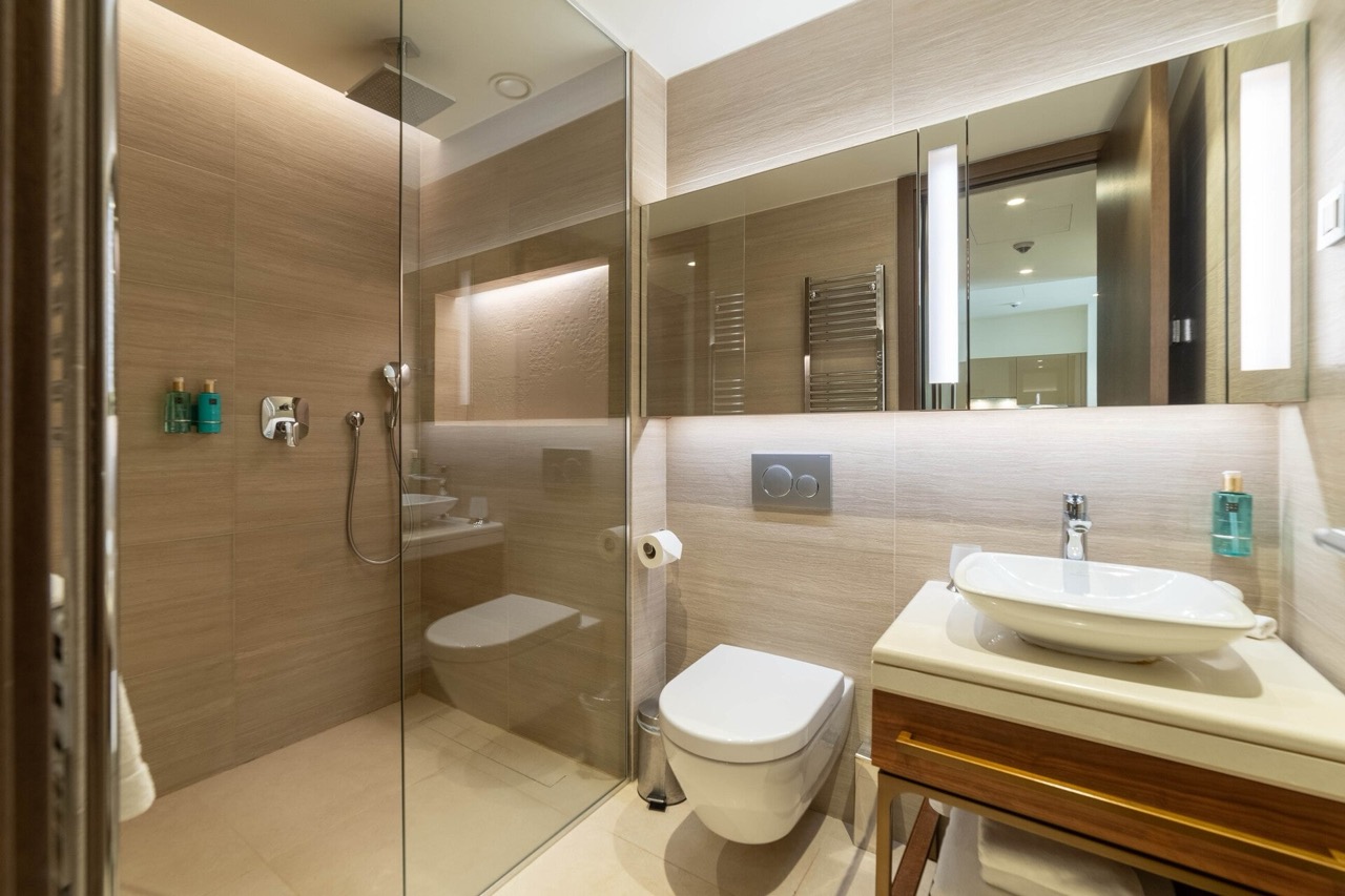 Modern bathroom in an apartment in Portonovi, Kumbor, Montenegro: glass shower, vessel sink, and lighting.
