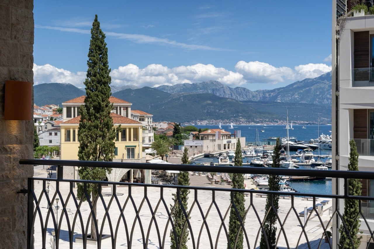 View from the apartment balcony in Portonovi, Kumbor, Montenegro: panoramic view of the yacht marina, the sea, and the mountains.