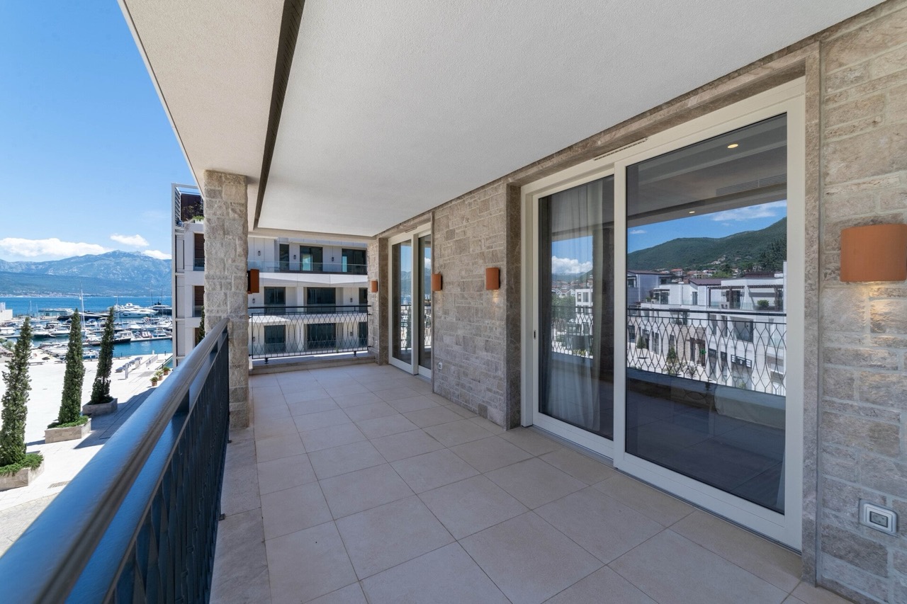 Spacious terrace with stone finishes and a view of Portonovi Marina, Kumbor, Montenegro.