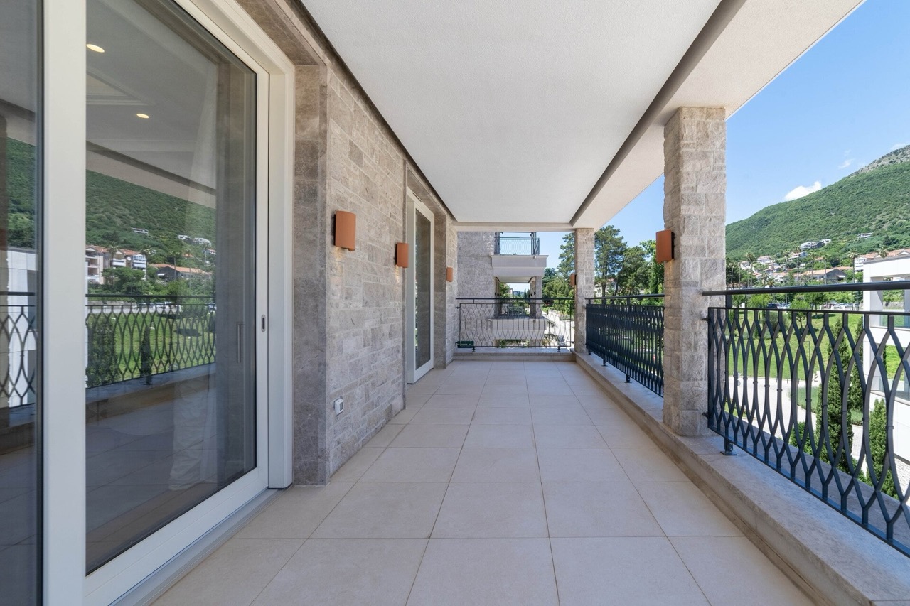 Spacious terrace with stone finishes and mountain views in an apartment at Portonovi, Kumbor, Montenegro.
