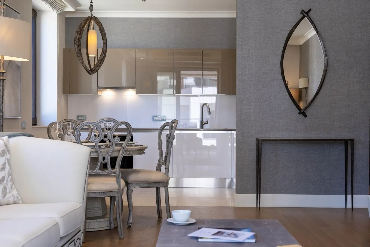 Living room with sofa, dining area, and open kitchen visible in the background.