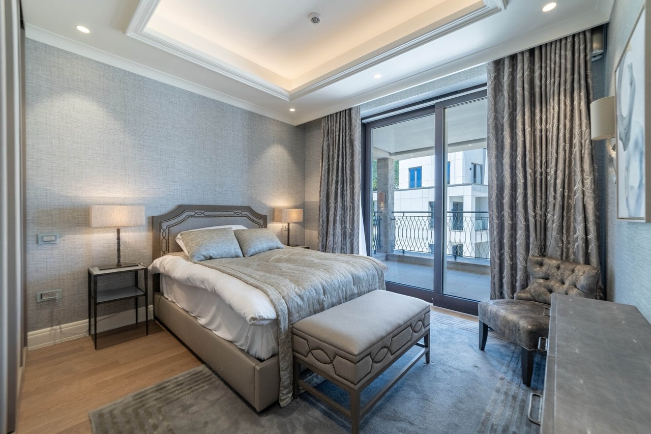 Modern bedroom in an apartment in Portonovi, Kumbor, Montenegro: double bed, balcony, and premium finishes.
