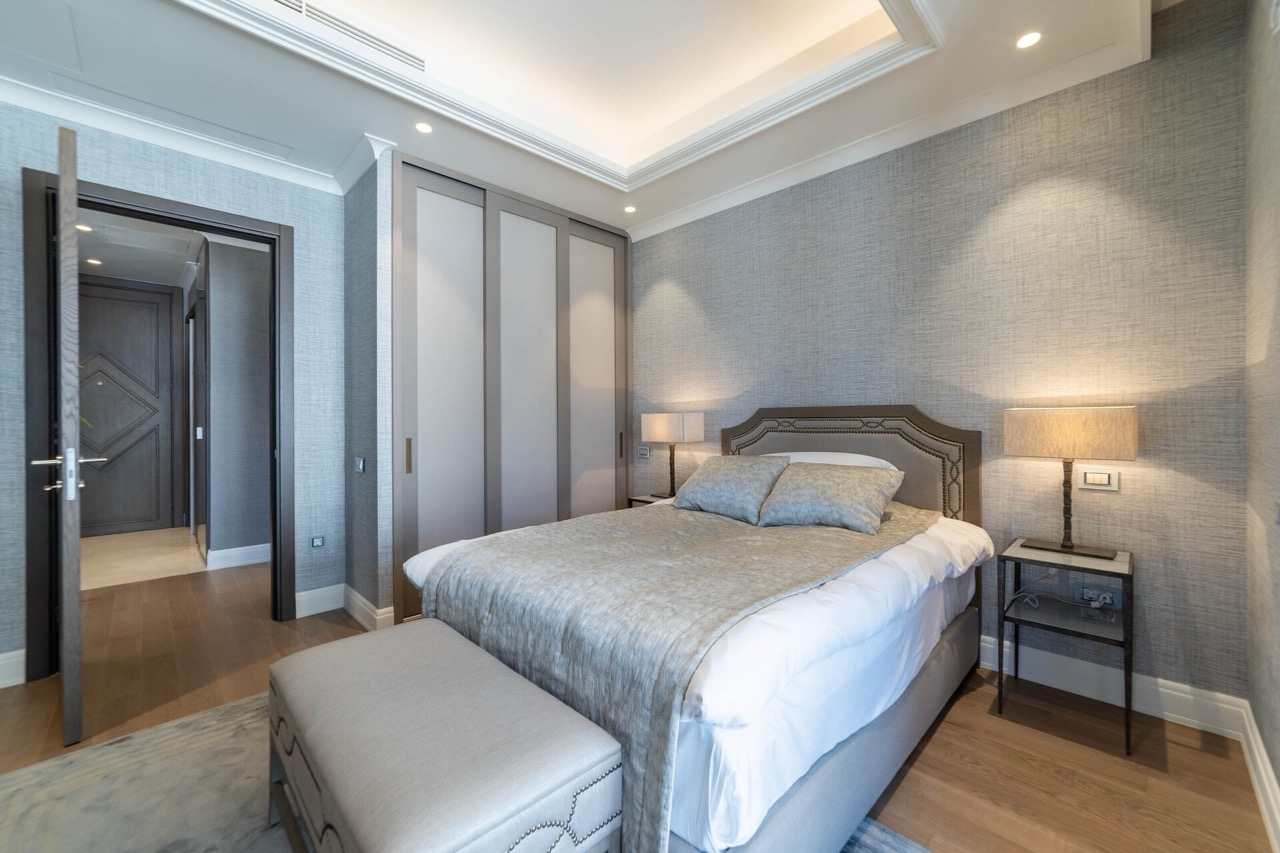Modern bedroom in an apartment in Portonovi, Kumbor, Montenegro: double bed, built-in wardrobe, and stylish decor.