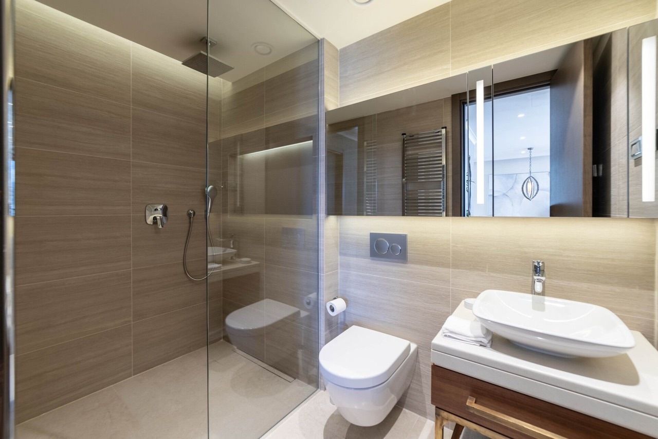 Modern bathroom in an apartment in Portonovi, Kumbor, Montenegro: shower cabin, stylish fixtures, and lighting.