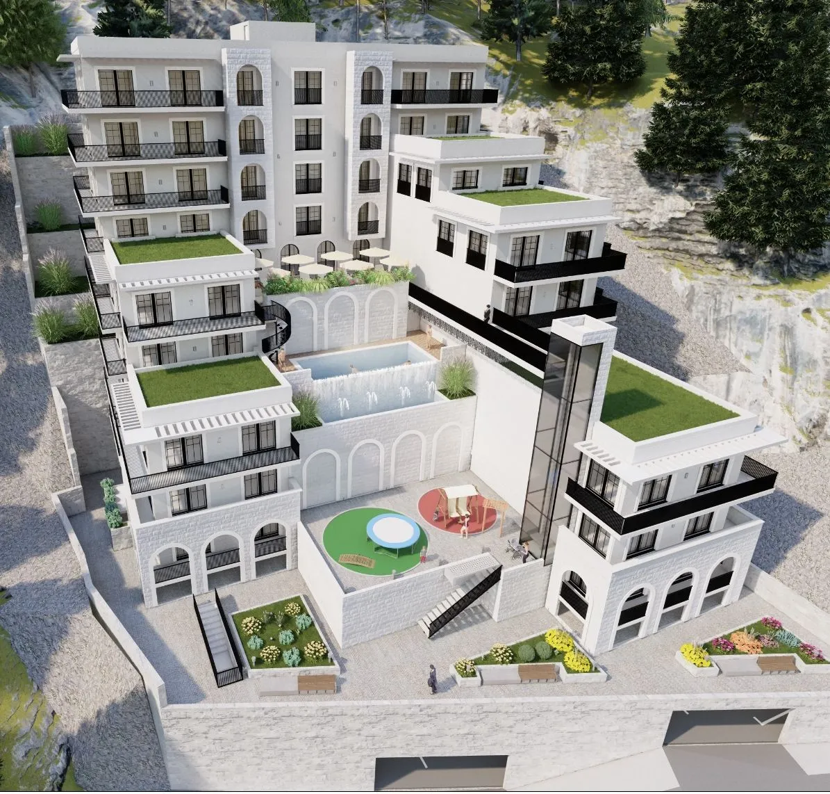 Aerial view of a white multi-story building complex featuring a pool, terraces, and a playground on a hillside.