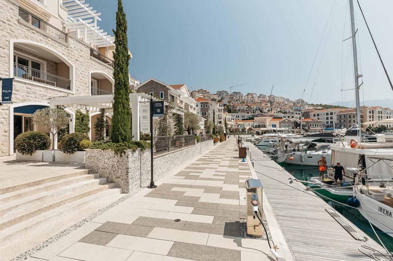 Marina Village waterfront and yacht marina in Luštica Bay, Radovići, Montenegro: stone buildings and sea view.