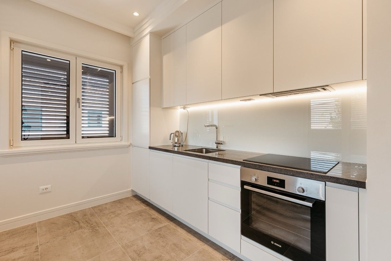 Modern white kitchen with Bosch appliances in an apartment in Luštica Bay, Radovići, Montenegro.