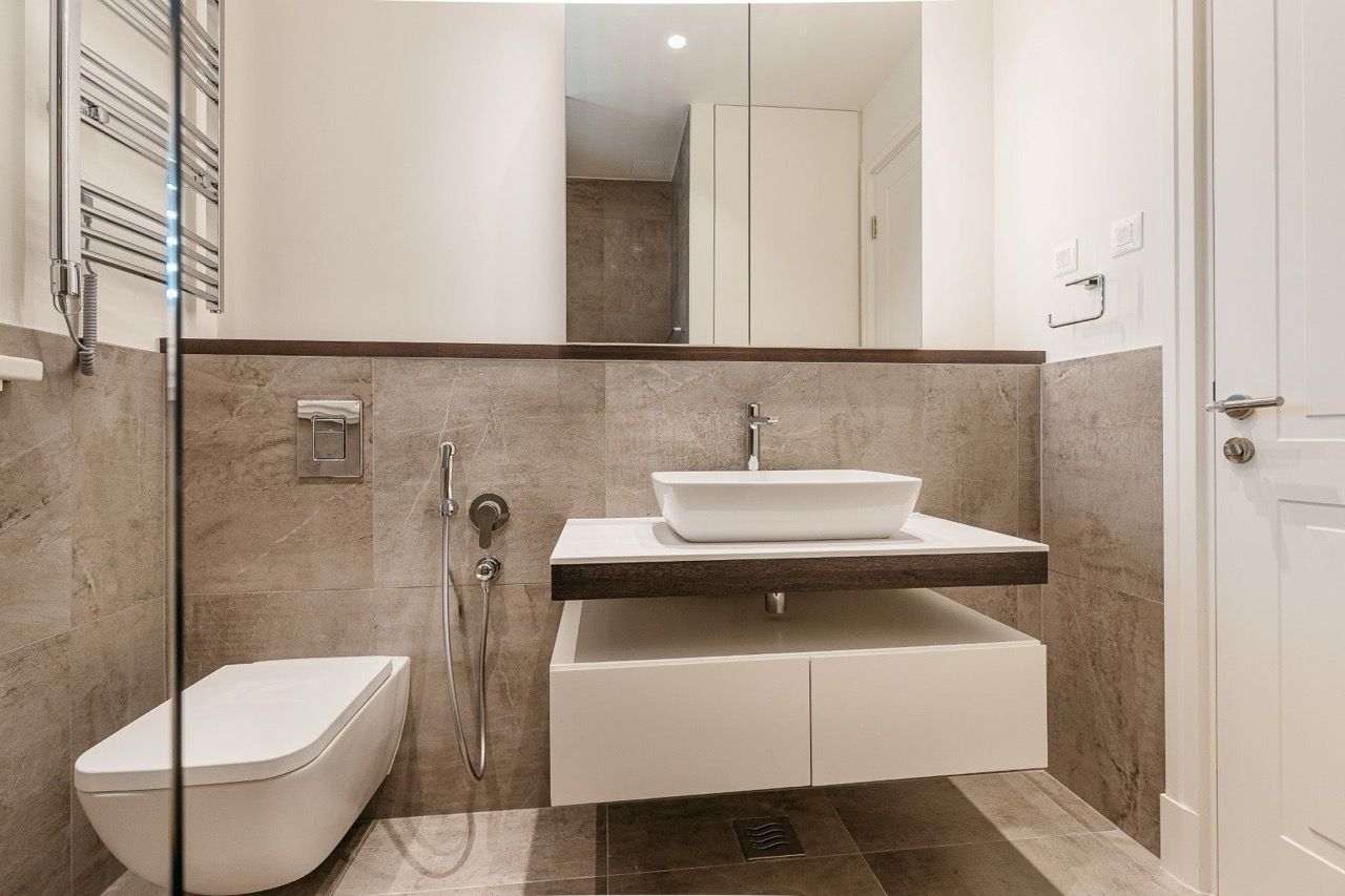 Modern bathroom in an apartment in Luštica Bay, Radovići, Montenegro: wall-mounted fixtures and stone finishes.