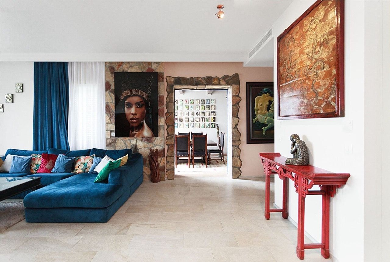 Living room with a blue sofa and stone finishes in a luxury villa in Luštica Bay, Radovići, Montenegro.