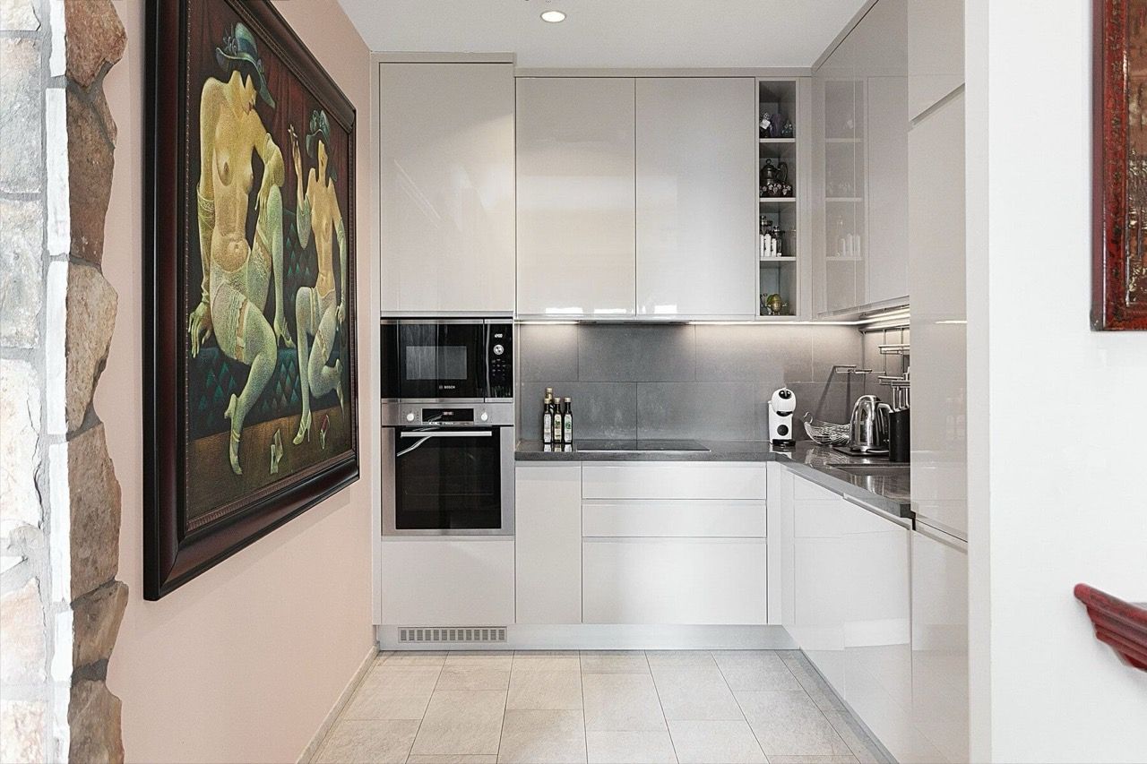 Modern kitchen with glossy fronts and built-in appliances in a villa in Luštica Bay, Radovići, Montenegro.