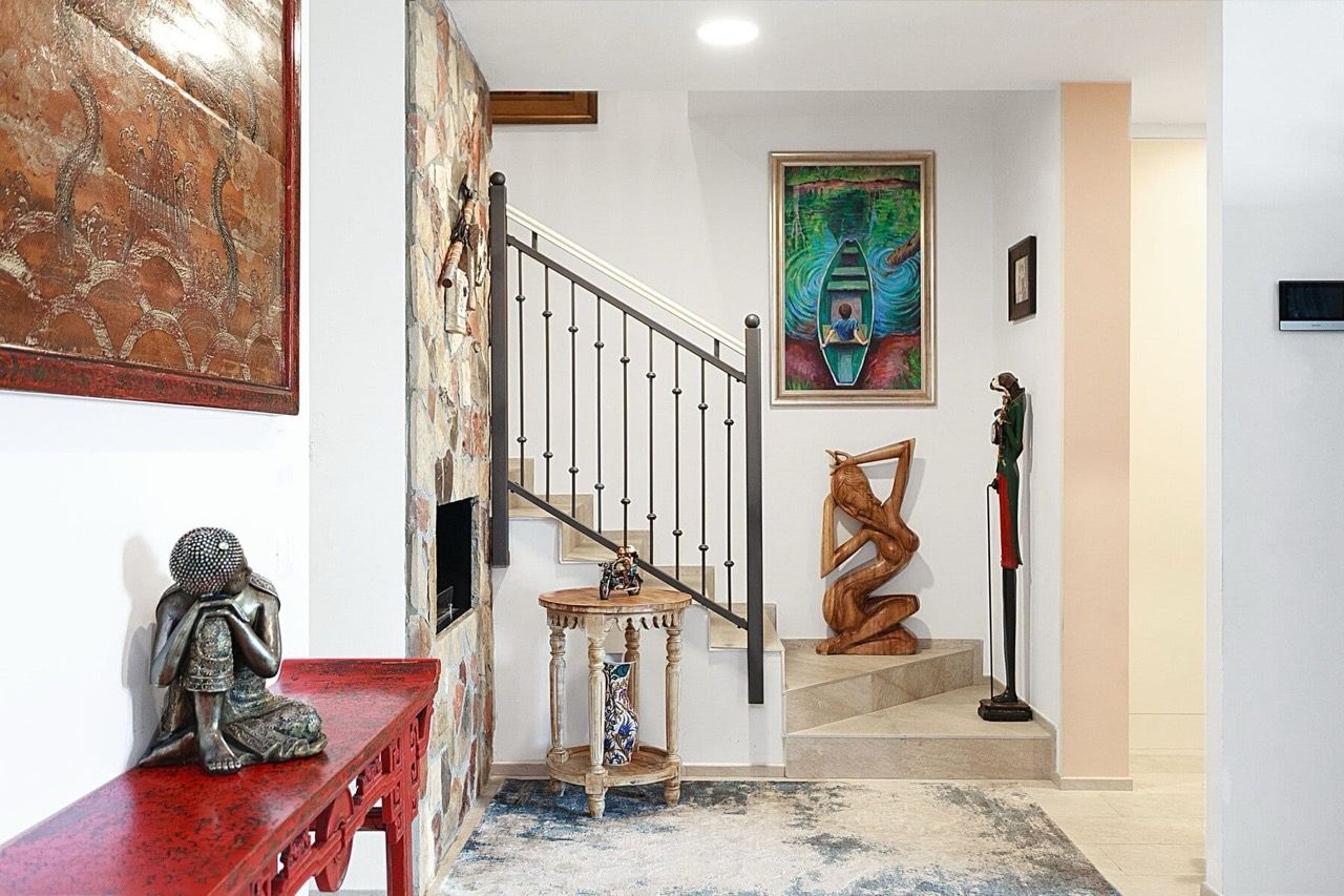 Living room interior in a villa in Luštica Bay, Radovići, Montenegro: staircase with wrought-iron railings and ethnic-style decor.