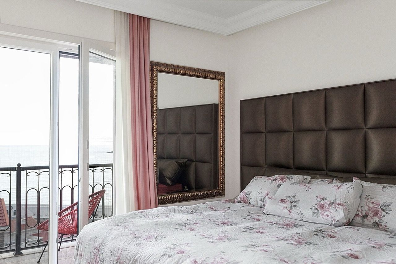 Bedroom with sea view in Luštica Bay villa, Radovići, Montenegro: double bed, mirror, and access to the balcony.