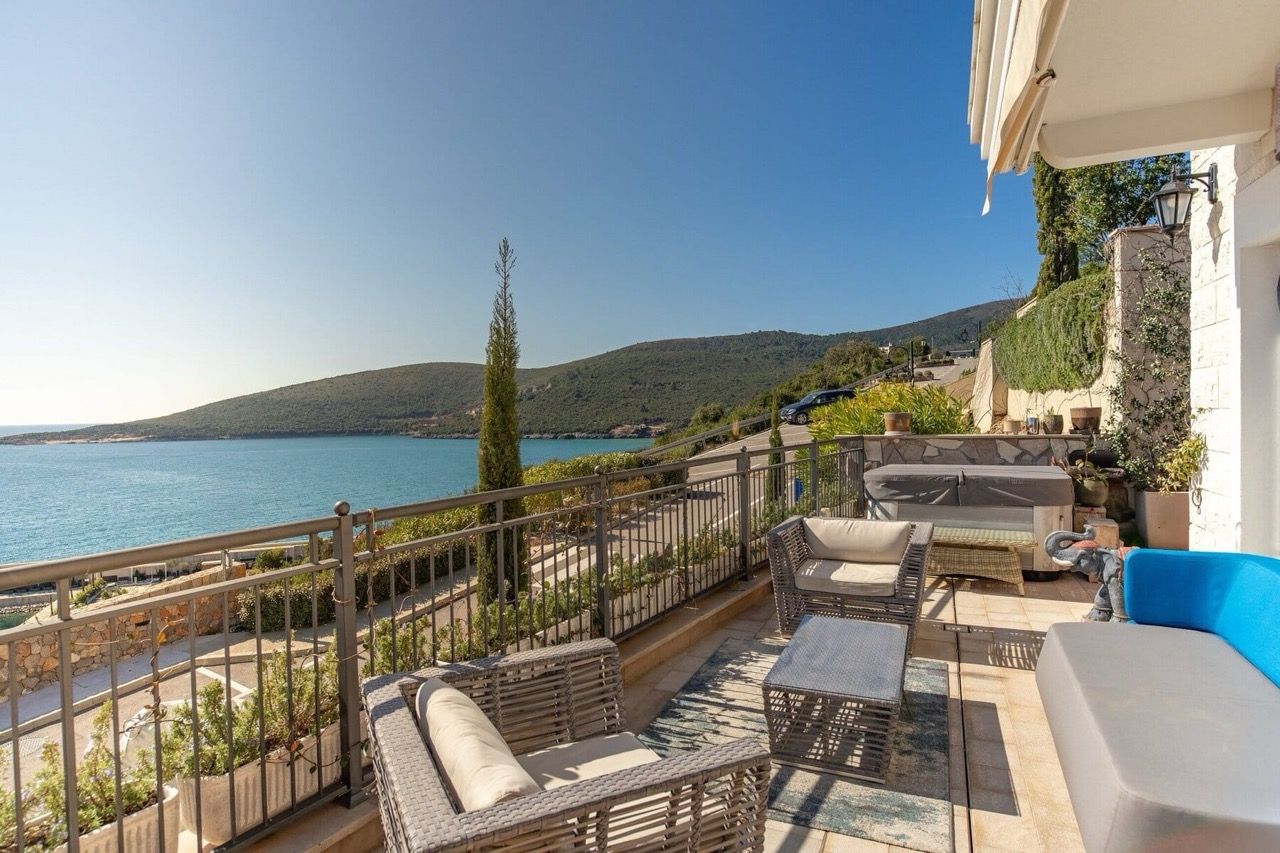 Terrace with furniture and a jacuzzi at a villa in Luštica Bay, Radovići, Montenegro, with panoramic views of the Adriatic Sea.