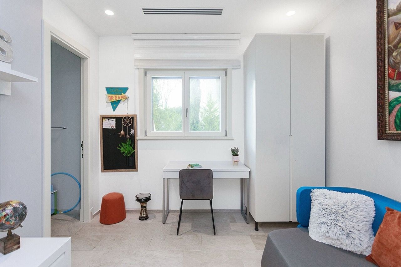 Modern bedroom with a desk and wardrobe in a villa in Luštica Bay, Radovići, Montenegro.