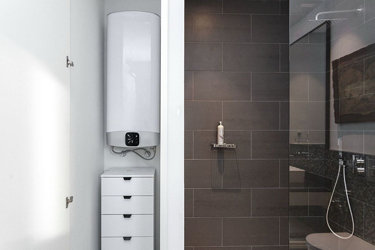 Modern bathroom in a villa in Luštica Bay, Radovići, Montenegro: shower cabin and built-in boiler.